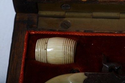 Lot 111 - A 19th century cased miniature pistols set The...