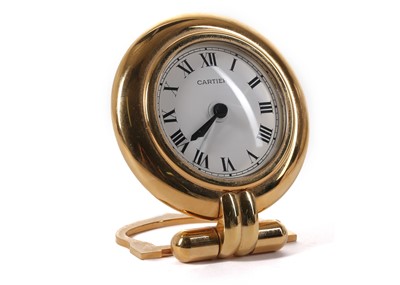 Lot 625 - Cartier gilt Colisee travel alarm clock,...