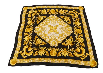 Lot 619 - Versace Atelier black and gold silk scarf,...