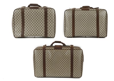 Lot 312 - Set of three graduated Gucci suitcases, 1990s,...