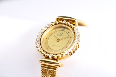 Lot 59 - OMEGA. AN 18K GOLD AND DIAMOND SET QUARTZ...