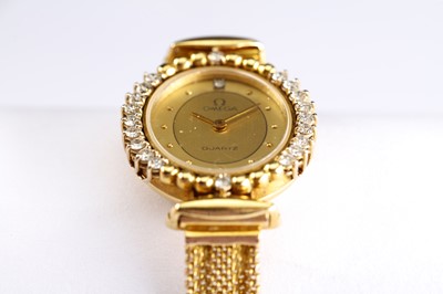 Lot 59 - OMEGA. AN 18K GOLD AND DIAMOND SET QUARTZ...