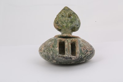 Lot 8 - AN EARLY GREEN-GLAZED POTTERY OIL LAMP...