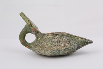 Lot 8 - AN EARLY GREEN-GLAZED POTTERY OIL LAMP...