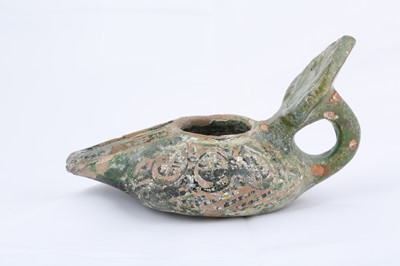 Lot 8 - AN EARLY GREEN-GLAZED POTTERY OIL LAMP...