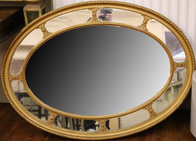 Lot 243 - An early 20th Century oval shaped wall mirror,...