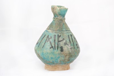 Lot 15 - A TURQUOISE-GLAZED POTTERY JUG WITH...