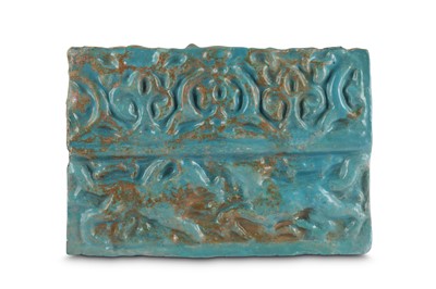 Lot 12 - A MOULDED TURQUOISE-GLAZED POTTERY TILE Kashan,...