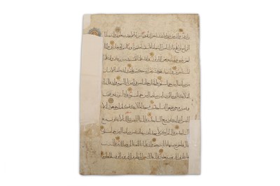 Lot 30 - A LOOSE FOLIO FROM A FATIMID QUR'AN  Egypt,...