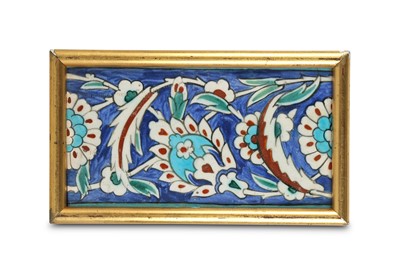 Lot 75 - AN IZNIK POLYCHROME POTTERY BORDER TILE...