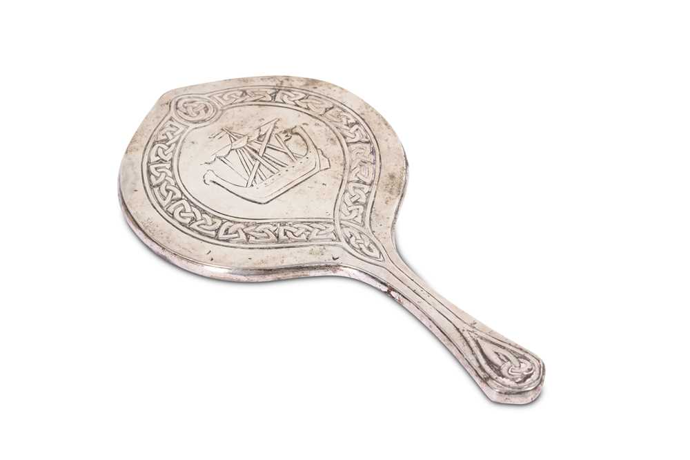 Lot 115 - An Arts and Craft silver-mounted hand mirror,...