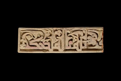 Lot 7 - A FATIMID MOULDED CALLIGRAPHIC POTTERY TILE...