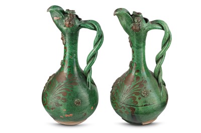 Lot 98 - TWO DARK GREEN-GLAZED CANAKKALE POTTERY EWERS ...