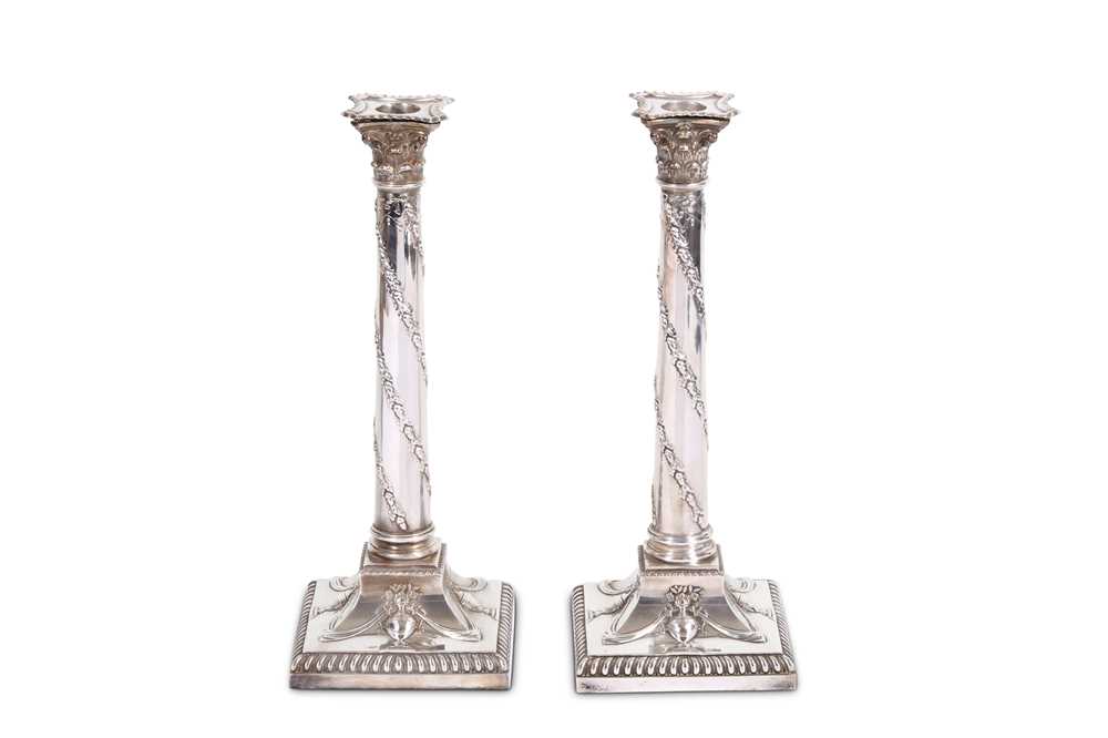 Lot 383 - A pair of silver plated column candlesticks,...