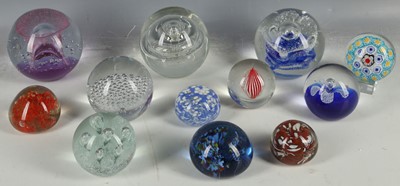 Lot 457 - A collection of twelve mixed size paperweights...