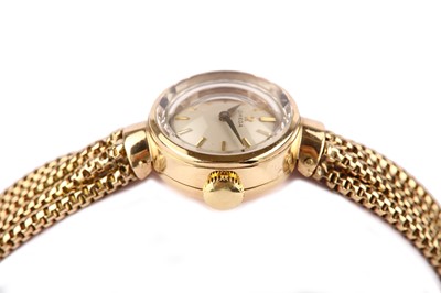 Lot 325 - OMEGA. A LADIES 9K GOLD AND DIAMOND SET MANUAL...