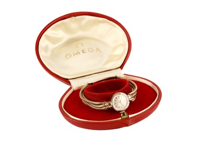 Lot 325 - OMEGA. A LADIES 9K GOLD AND DIAMOND SET MANUAL...