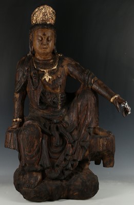 Lot 464 - A Chinese wooden carving of Guanyin seated in...