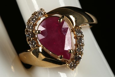 Lot 218 - An 18ct yellow gold, ruby and diamond cluster...