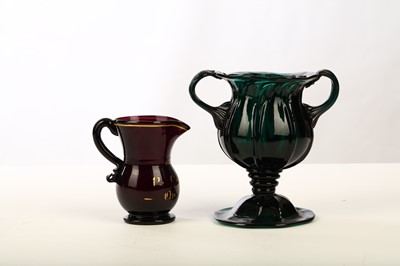 Lot 208 - AN UNUSUAL EMERALD-GREEN MOULDED GLASS LOVING...