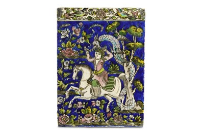 Lot 150 - A QAJAR MOULDED POTTERY TILE WITH RIDER AND...