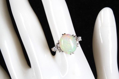 Lot 150 - Opal ring with diamonds at shoulders.