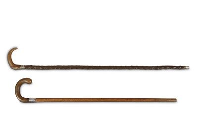 Lot 457 - TWO CANES WITH RHINOCEROS HORN HANDLES. Circa...
