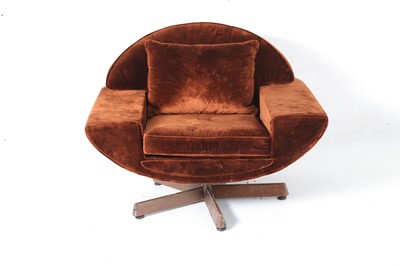 Lot 670 - A 1970s brown velvet upholstered swivel chair,...