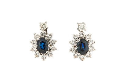 Lot 151 - A pair of sapphire and diamond cluster...