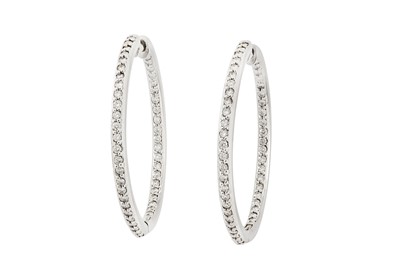 Lot 31 - A pair of diamond hoop earrings Each set to...