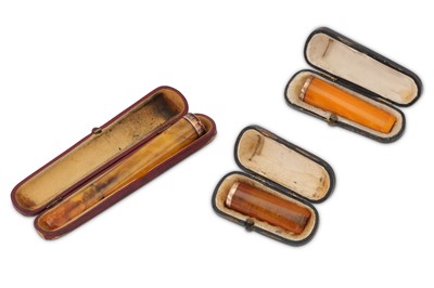 Lot 311 - Three cased amber coloured cheroot holders,...