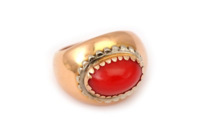 Lot 405 - A coral ring The oval cabochon coral Corallium...