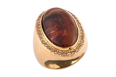 Lot 100 - A fire agate and diamond ring The oval fire...