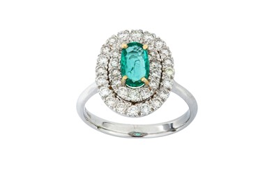 Lot 12 - An emerald and diamond ring  Set with an...