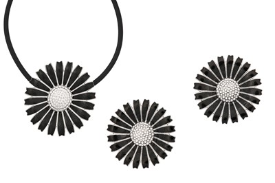 Lot 56 - A black enamel 'Daisy' pendant and earclips,...