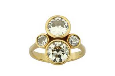 Lot 85 - A diamond dress ring Centred by four old...