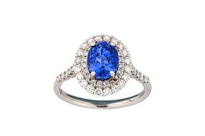 Lot 26 - A sapphire and diamond cluster ring The...