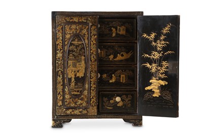 Lot 74 - A CHINESE GILT-DECORATED BLACK LACQUER CABINET....