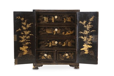 Lot 74 - A CHINESE GILT-DECORATED BLACK LACQUER CABINET....