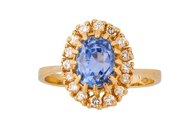 Lot 135 - A sapphire and diamond cluster ring The...