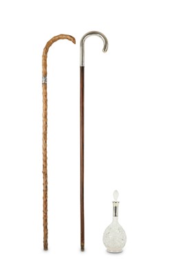 Lot 324 - A walking cane with a sterling silver handle,...