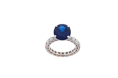 Lot 267 - A sapphire and diamond ring  The oval-cut...