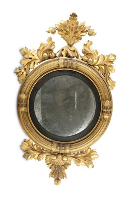 Lot 625 - A Regency circular convex mirror with a carved...