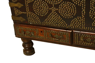 Lot 57 - A TEAK AND BRASS STUDDED ZANZIBAR CHEST. With...