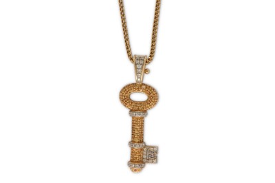 Lot 172 - A diamond and yellow sapphire key pendant...