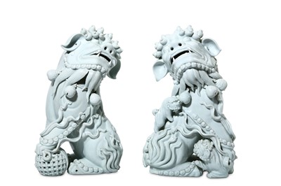Lot 52 - A PAIR OF CHINESE BLANC-DE-CHINE LION DOGS....