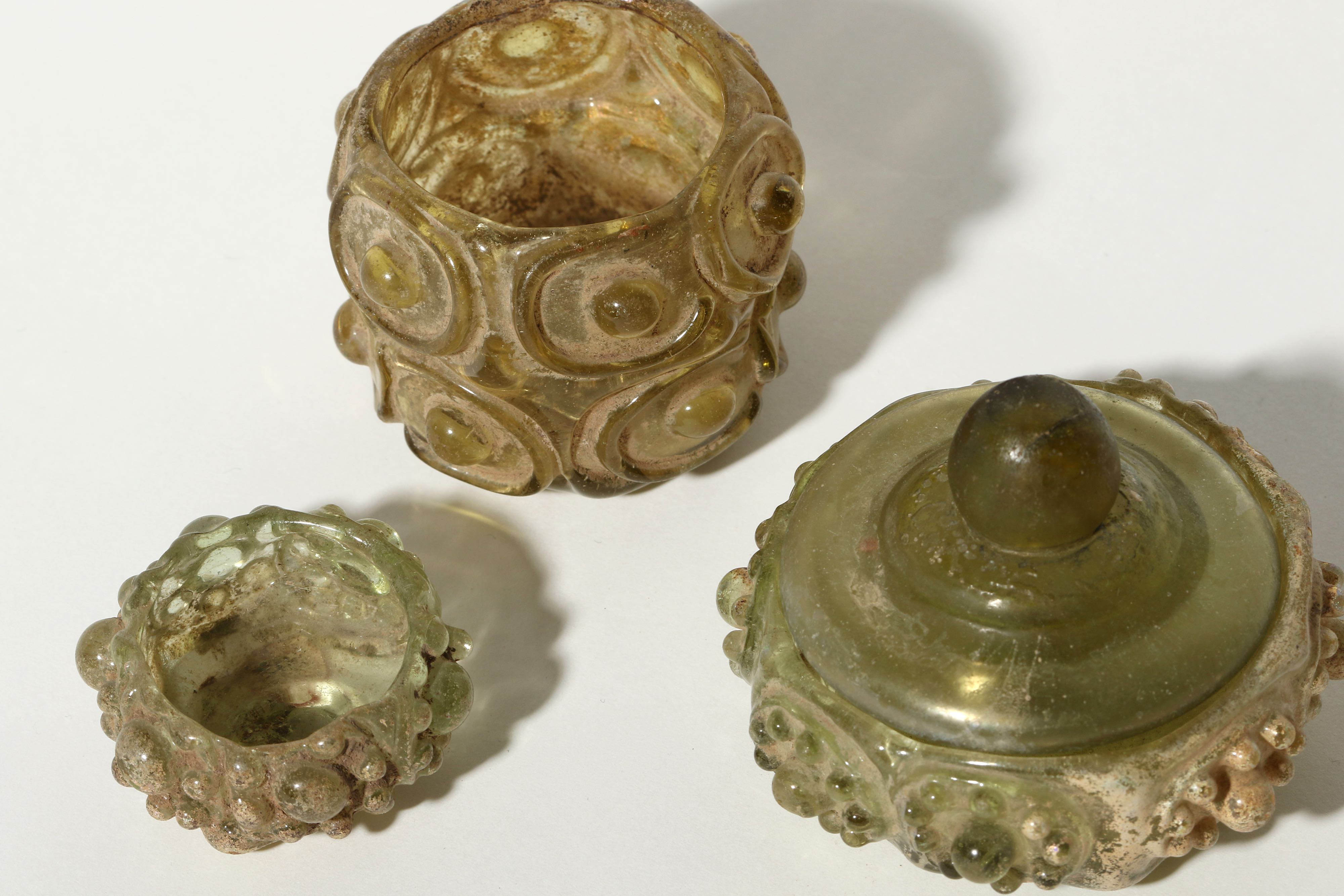 Lot 177 - THREE GREEN GLASS PYXIDES Circa 11th Century