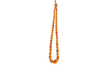 Lot 110 - An amber necklace A graduated strand of...