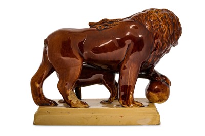 Lot 15 - A STAFFORDSHIRE POTTERY TREACLE-GLAZED MODEL...