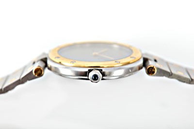Lot 267 - CARTIER. A STAINLESS STEEL AND GOLD QUARTZ...